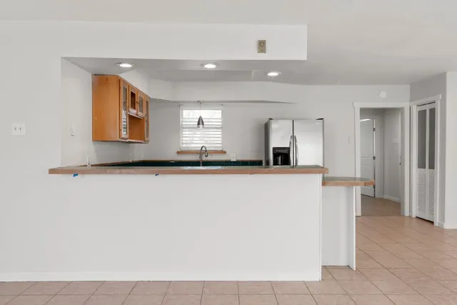 a living room with a couch and a refrigerator