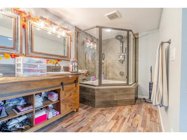 a bathroom with a sink a vanity and a large mirror
