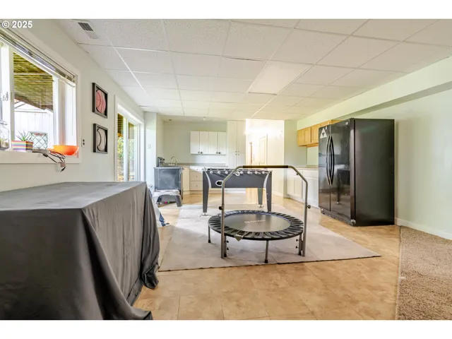 a living room with stainless steel appliances kitchen island granite countertop furniture and a kitchen view