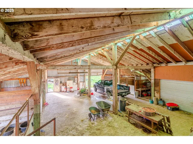 a view of large space in front of a house with a garden