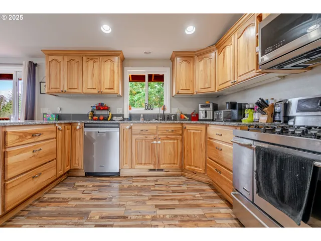 a kitchen with white cabinets sink and window