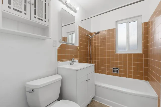 a bathroom with a toilet a sink and bathtub