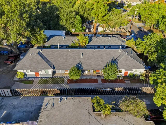 an aerial view of a house with swimming pool and outdoor seating