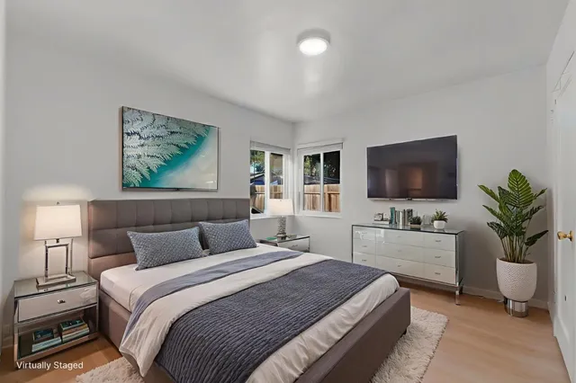 a bedroom with a bed and a flat screen tv