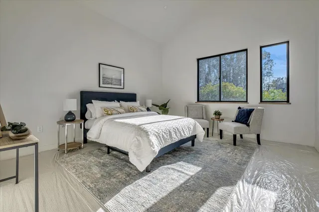 a bedroom with a bed and a couch