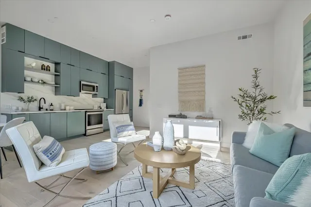 a living room with furniture a fireplace and a table