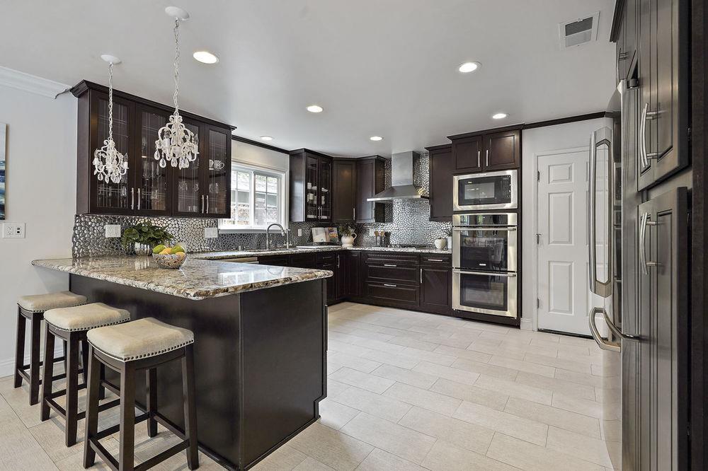 222 Thomas Drive Los Gatos, CA 95032 - Photo 1 of 28 a kitchen with stainless steel appliances granite countertop a refrigerator a sink a stove a oven a dining table and chairs