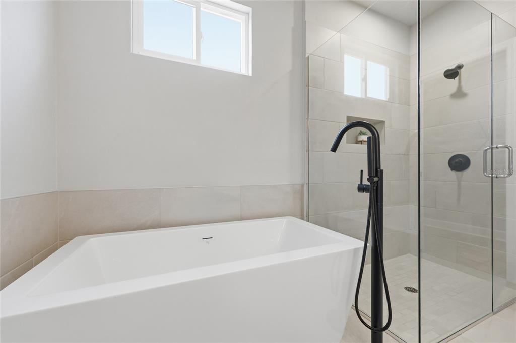 9533 Southwest 66th Lane Gainesville, FL 32608 - Photo 19 of 32 a white bath tub sitting next to a shower