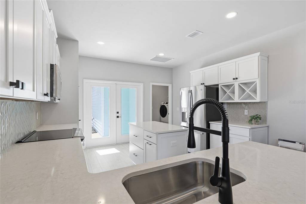 9533 Southwest 66th Lane Gainesville, FL 32608 - Photo 21 of 32 a kitchen with stainless steel appliances a sink cabinets and wooden floor