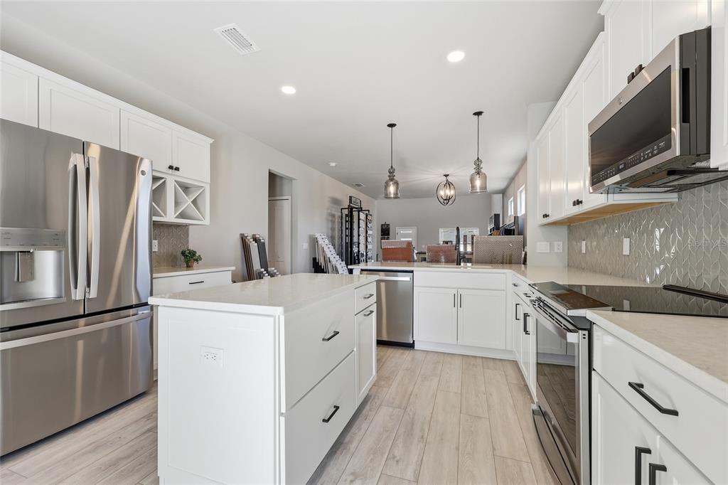 9533 Southwest 66th Lane Gainesville, FL 32608 - Photo 22 of 32 a kitchen with white cabinets stainless steel appliances and sink
