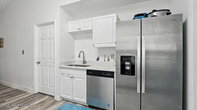 a kitchen with a sink and refrigerator