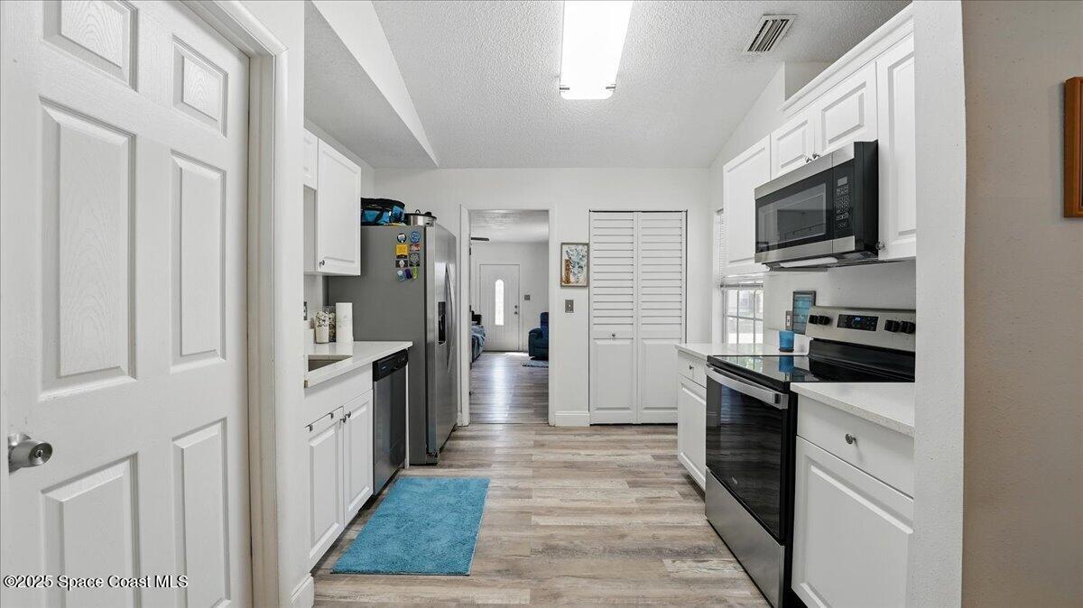 6615 Dock Avenue Cocoa, FL 32927 - Photo 13 of 38 a kitchen with cabinets and stainless steel appliances