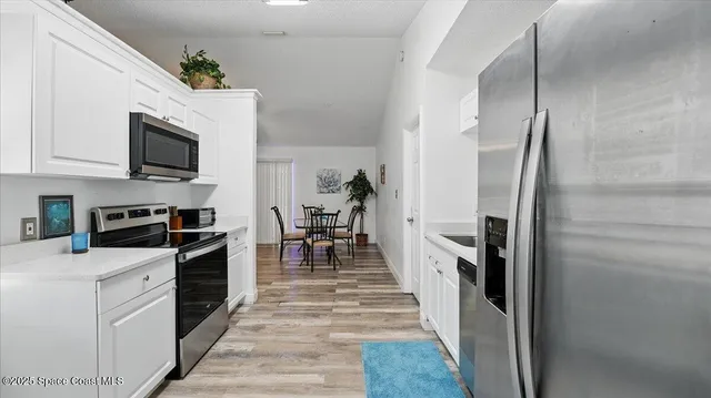 a kitchen with stainless steel appliances granite countertop a refrigerator stove and oven