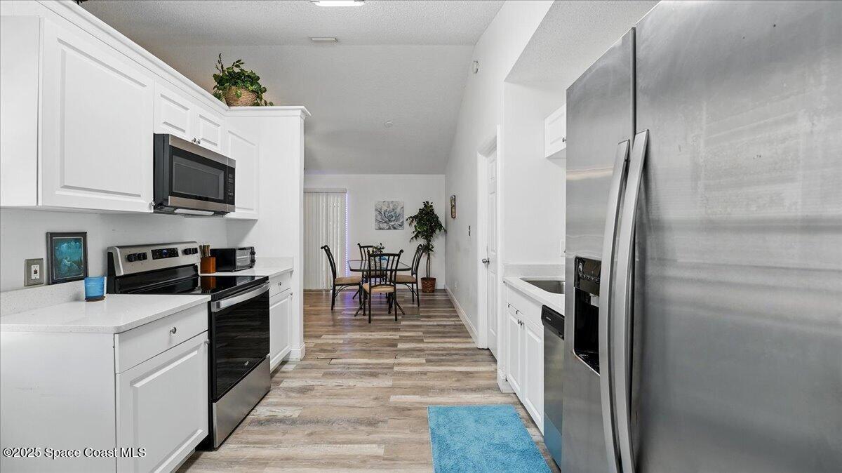 6615 Dock Avenue Cocoa, FL 32927 - Photo 14 of 38 a kitchen with stainless steel appliances granite countertop a refrigerator stove and oven