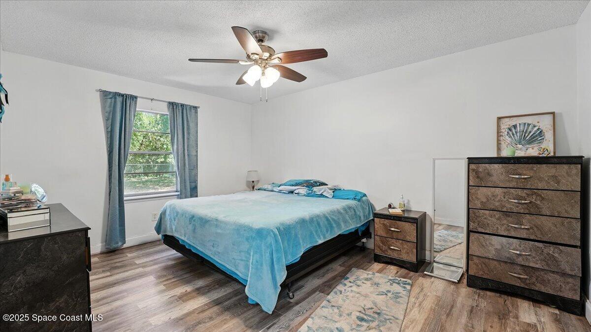 6615 Dock Avenue Cocoa, FL 32927 - Photo 15 of 38 a bedroom with a bed and a dresser