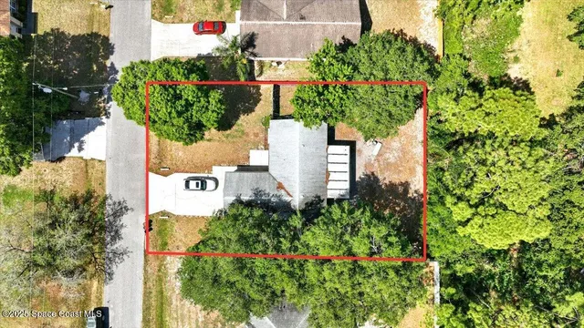 an aerial view of residential house with sign board and yard