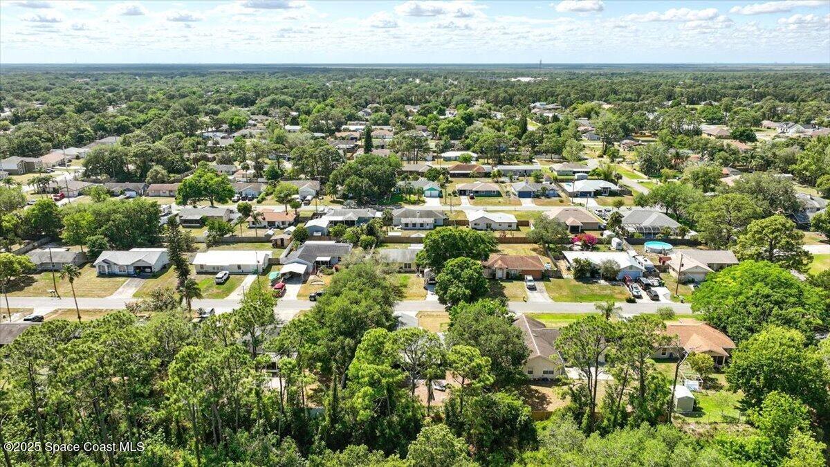 6615 Dock Avenue Cocoa, FL 32927 - Photo 33 of 38 an aerial view of residential houses with outdoor space and trees