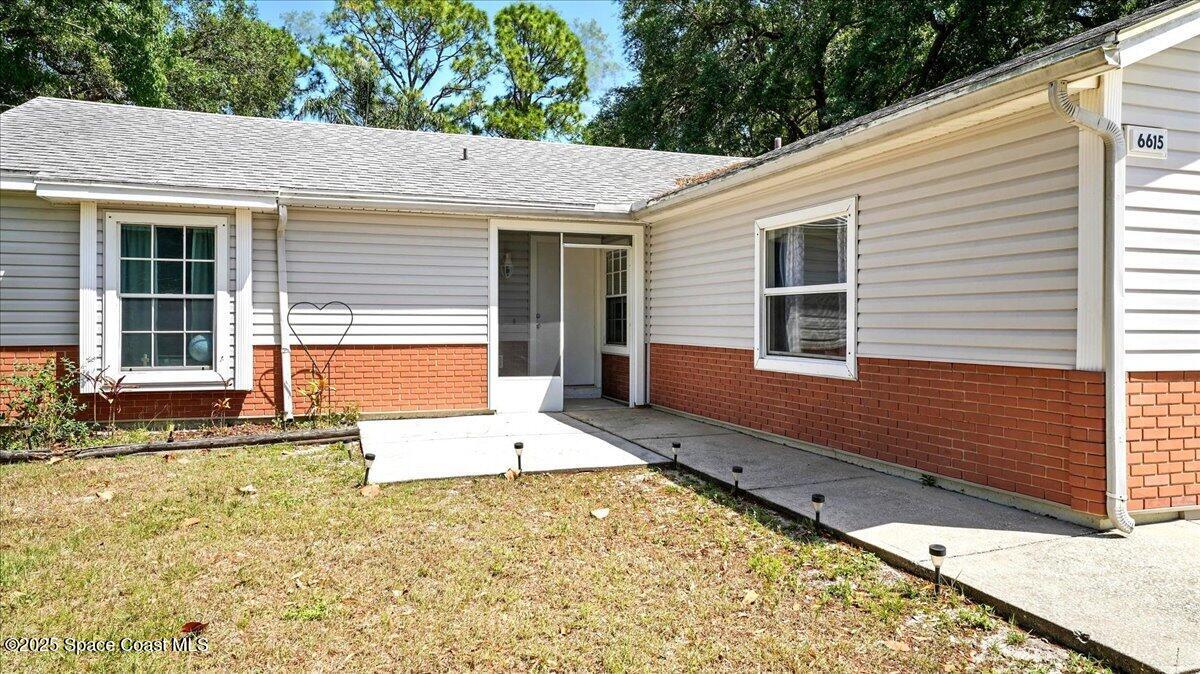 6615 Dock Avenue Cocoa, FL 32927 - Photo 4 of 38 a view of a backyard with a large tree