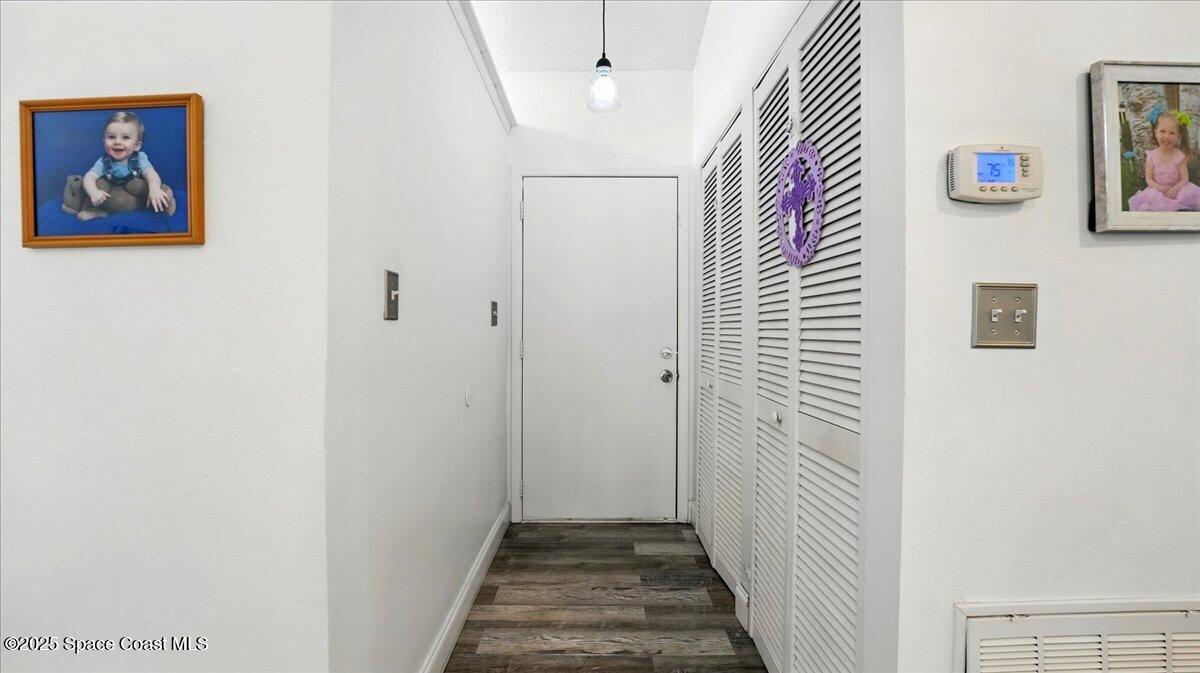 6615 Dock Avenue Cocoa, FL 32927 - Photo 5 of 38 a view of a hallway with paintings on the wall