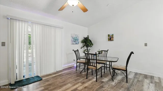 a view of a dining room with furniture and wooden floor