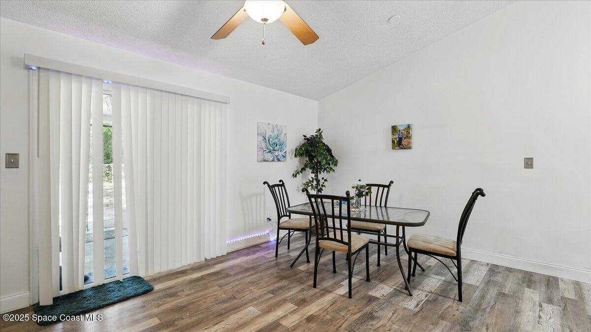 6615 Dock Avenue Cocoa, FL 32927 - Photo 7 of 38 a view of a dining room with furniture and wooden floor