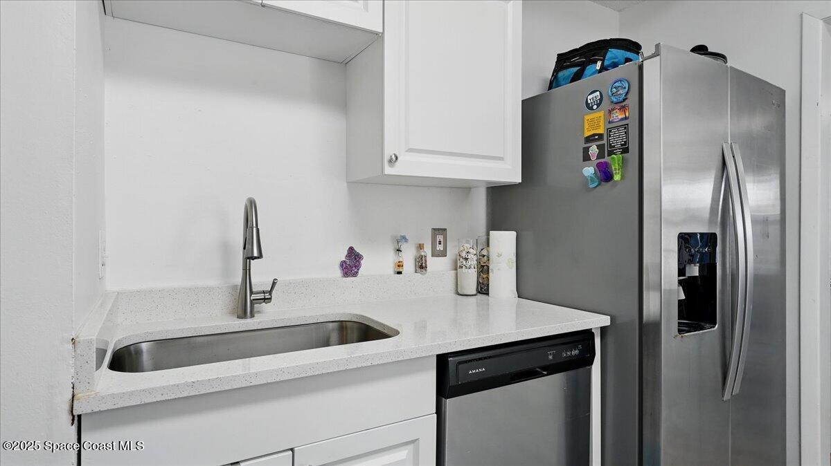 6615 Dock Avenue Cocoa, FL 32927 - Photo 10 of 38 a kitchen with stainless steel appliances granite countertop a sink and a refrigerator