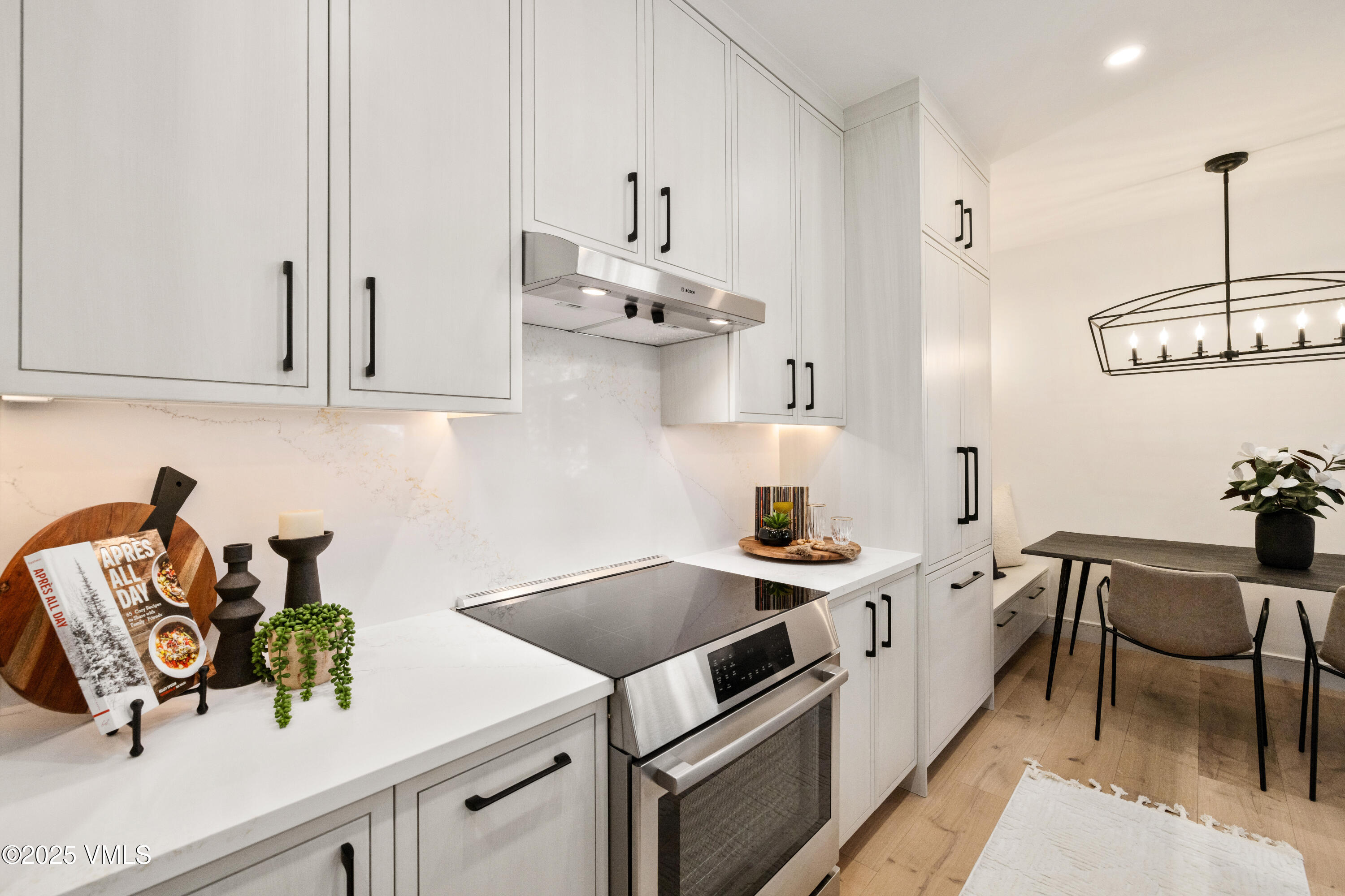 1881 Lions Ridge Loop, Unit 2 Vail, CO 81657 - Photo 11 of 41 a kitchen with stainless steel appliances a sink a stove and a wooden floors