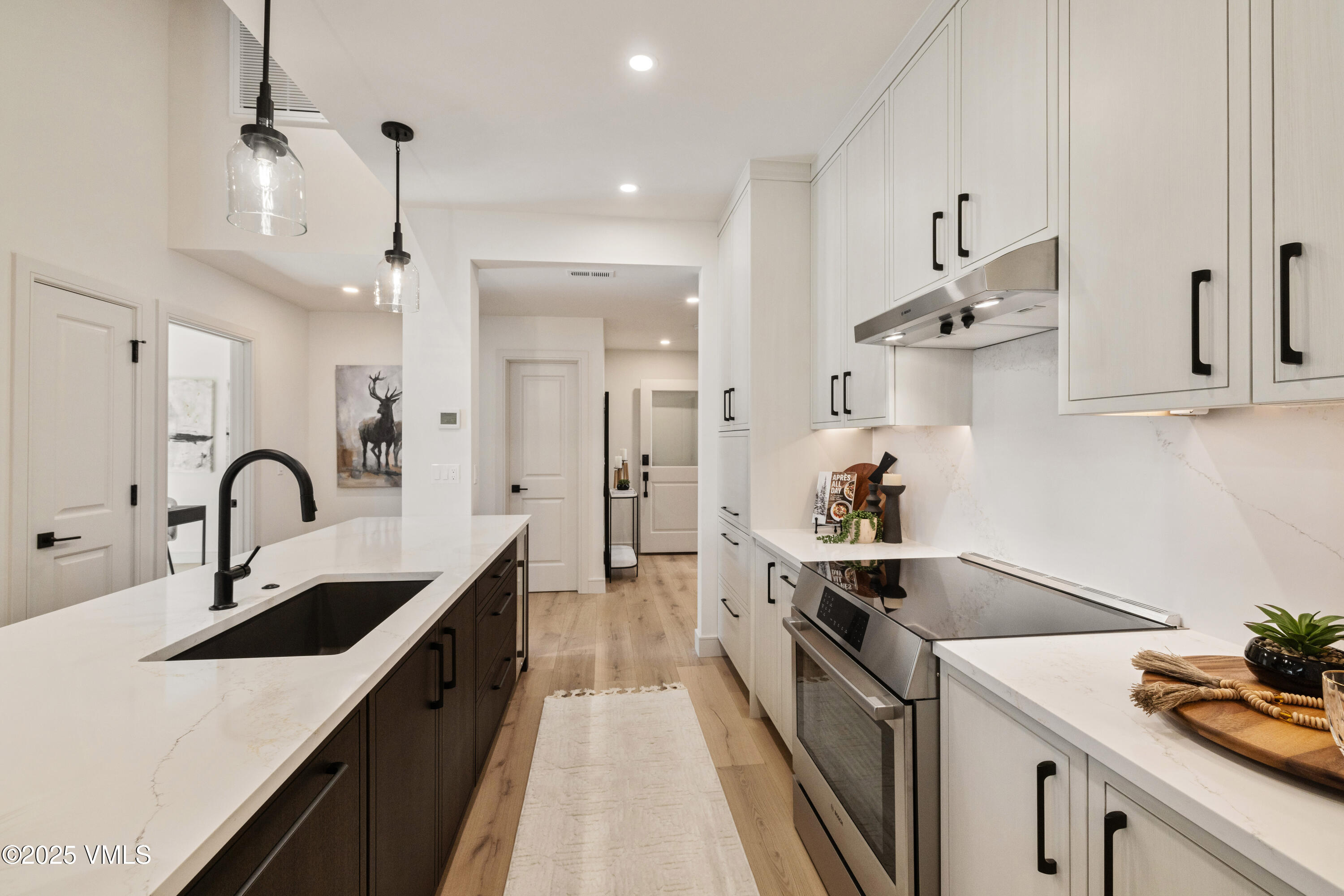 1881 Lions Ridge Loop, Unit 2 Vail, CO 81657 - Photo 13 of 41 a kitchen with kitchen island a sink stove and refrigerator