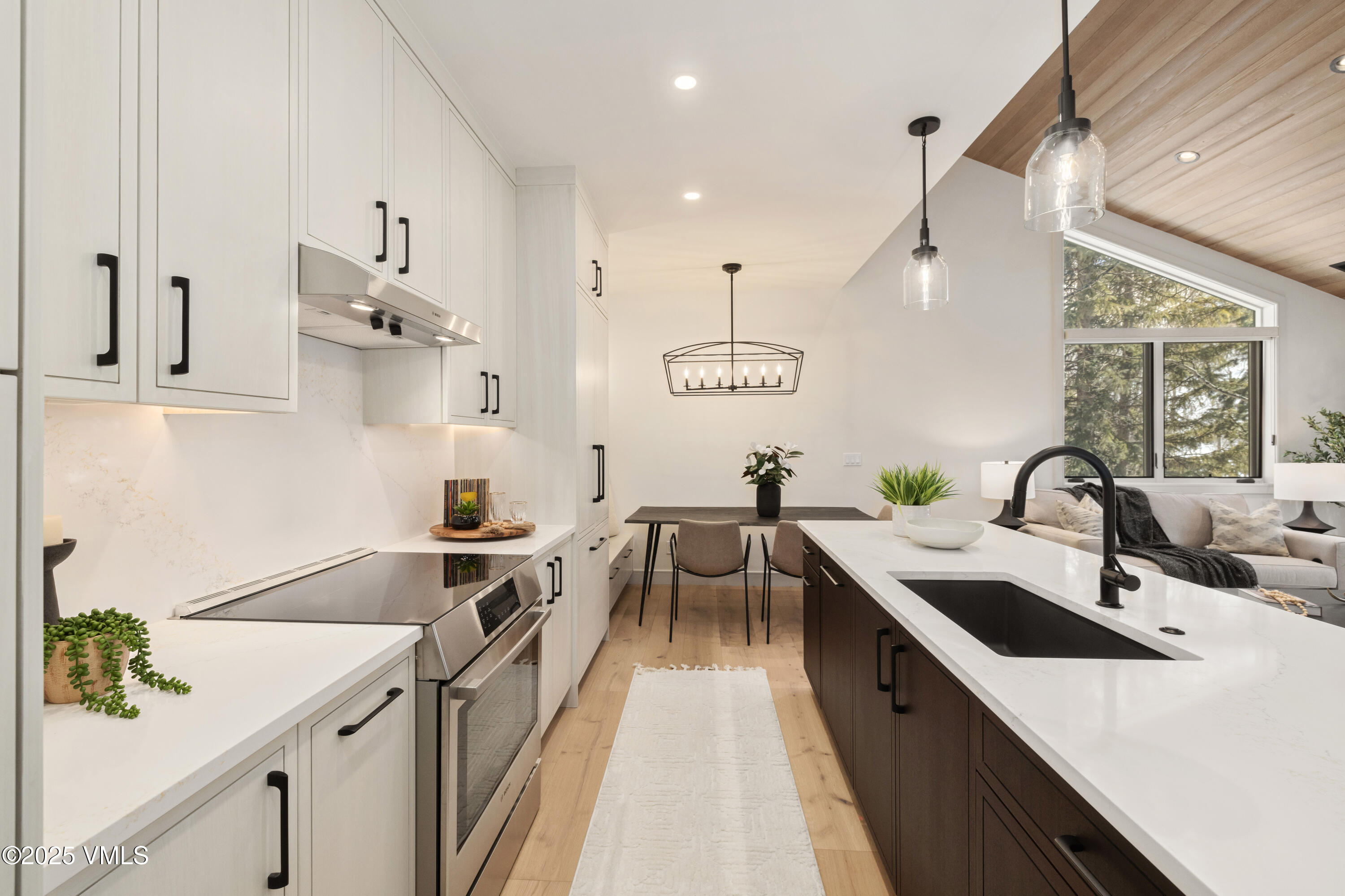 1881 Lions Ridge Loop, Unit 2 Vail, CO 81657 - Photo 8 of 41 a kitchen with a sink a counter space appliances and cabinets