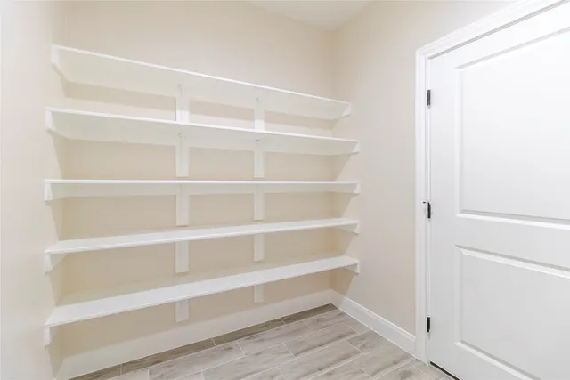 a view of walk in closet with empty racks