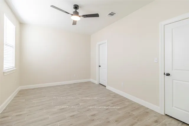 a view of room with a ceiling fan and window