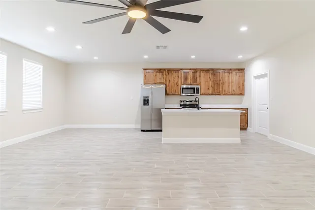 a view of a kitchen with a sink and a window
