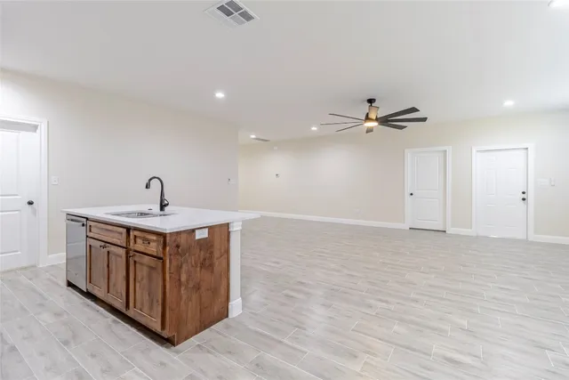 a view of an empty room and wooden floor