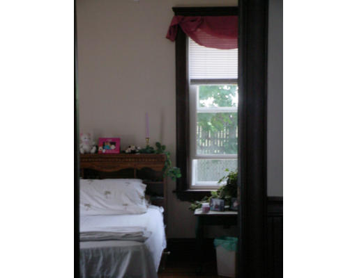 1457 Rodman Street Fall River, MA 02721 - Photo 11 of 16 a room with a table and a potted plant