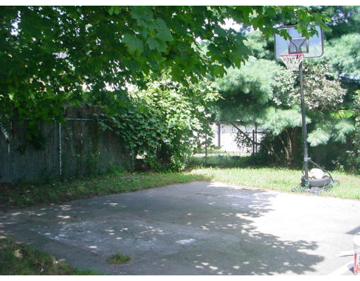 1457 Rodman Street Fall River, MA 02721 - Photo 14 of 16 a view of a yard with plants and large trees