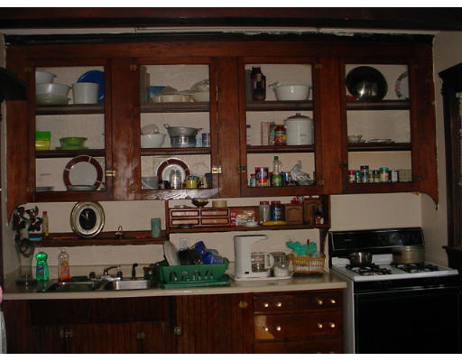 1457 Rodman Street Fall River, MA 02721 - Photo 3 of 16 a kitchen with a stove and cabinets