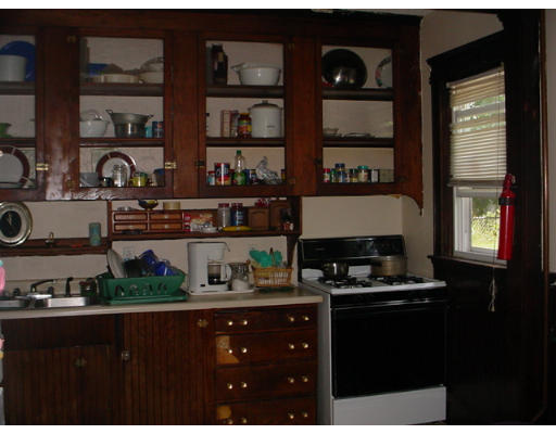 1457 Rodman Street Fall River, MA 02721 - Photo 8 of 16 a kitchen with a cabinets and a stove