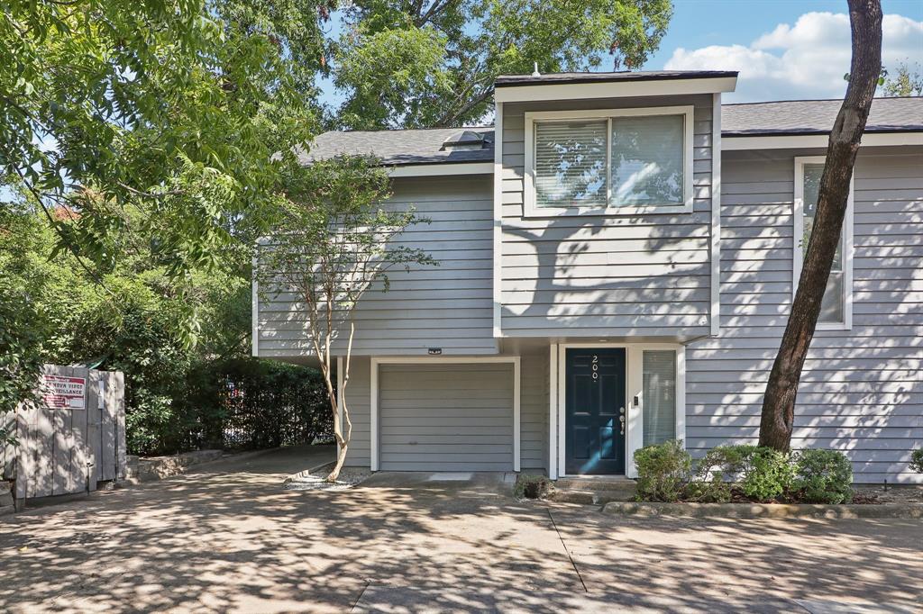 9222 Church Road, Unit 200 Dallas, TX 75231 - Photo 1 of 1 View of front facade with a garage