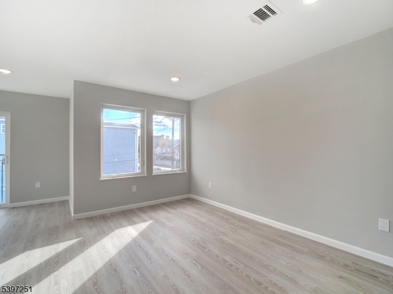 32 North 14th Street, Unit 2 Newark, NJ 07107 - Photo 11 of 14 an empty room with wooden floor and windows