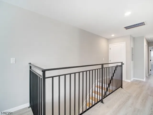 a view of hallway with wooden floor