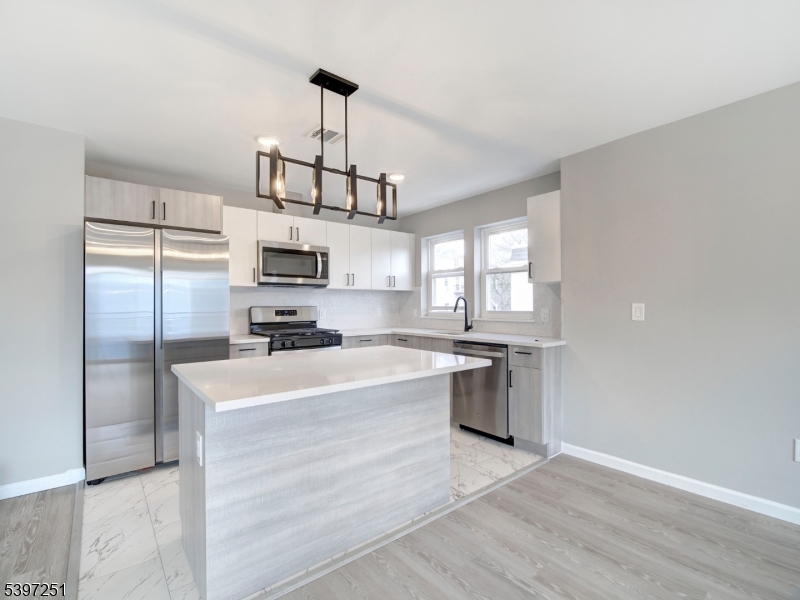 32 North 14th Street, Unit 2 Newark, NJ 07107 - Photo 4 of 14 a kitchen with a refrigerator a stove top oven a sink and dishwasher