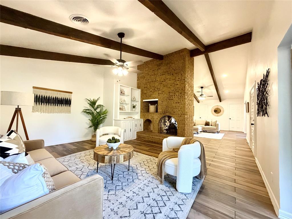 a living room with furniture and wooden floor