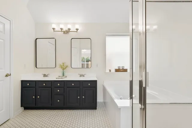 a bathroom with a double vanity sink and a mirror