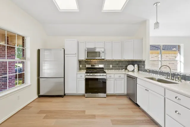 a kitchen with a sink stove and refrigerator