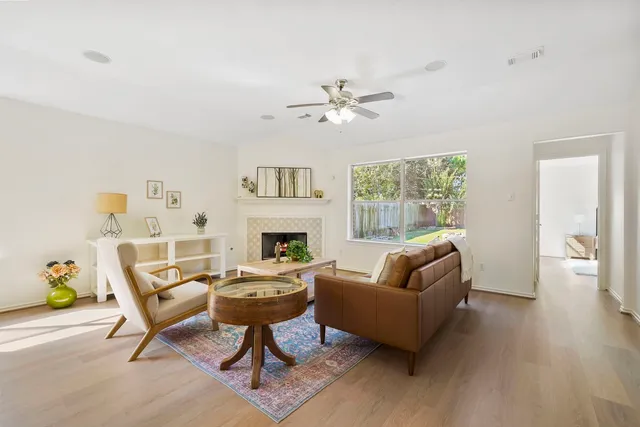 a living room with furniture a fireplace and a table