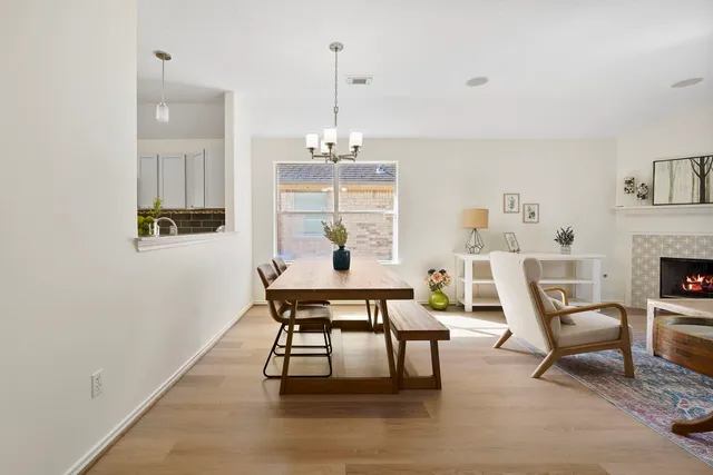 a view of a dining room with furniture wooden floor and a chandelier