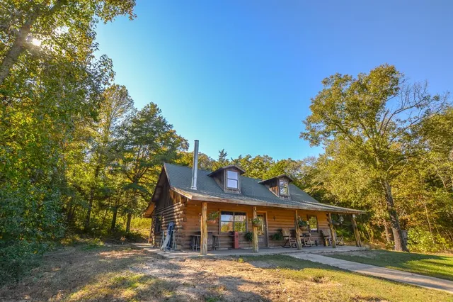 a view of a patio with table and chairs a barbeque with wooden fence