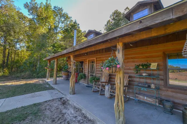a living room with furniture and a dining table