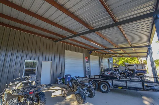 a living room with furniture and a dining table with kitchen view