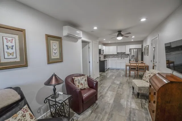 a view of a livingroom with furniture and a flat screen tv